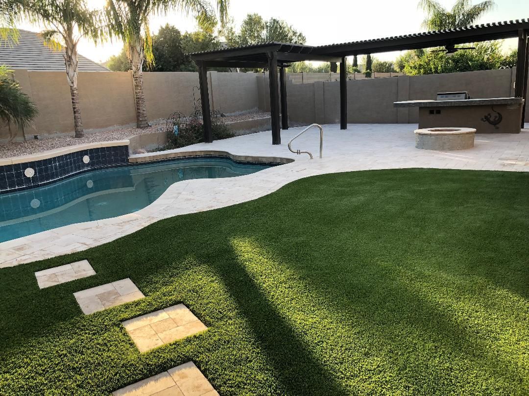 Backyard with a swimming pool and a pergola.