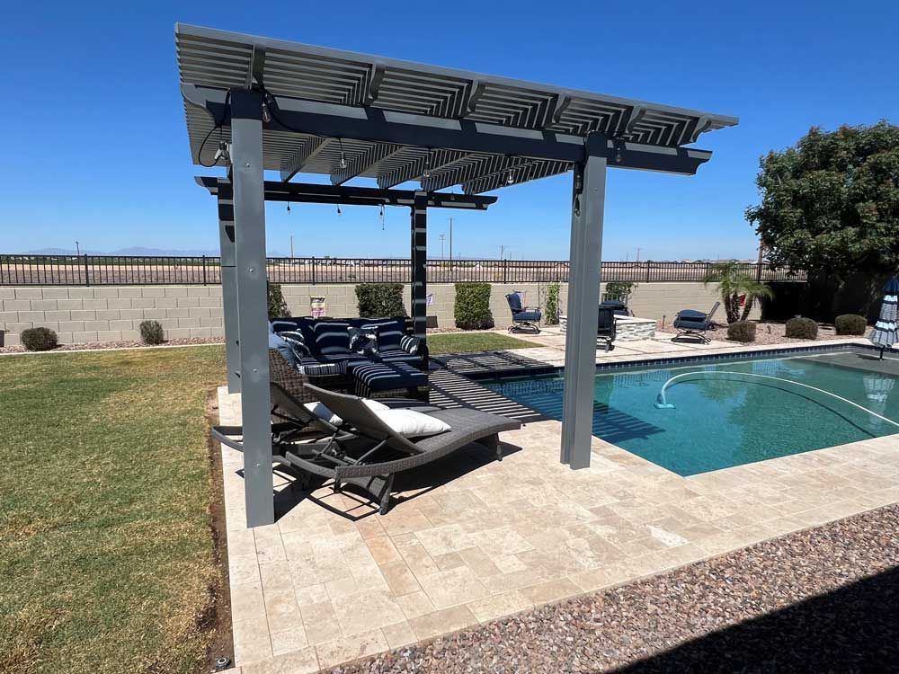 A swimming pool with a pergola and chairs in front of it.