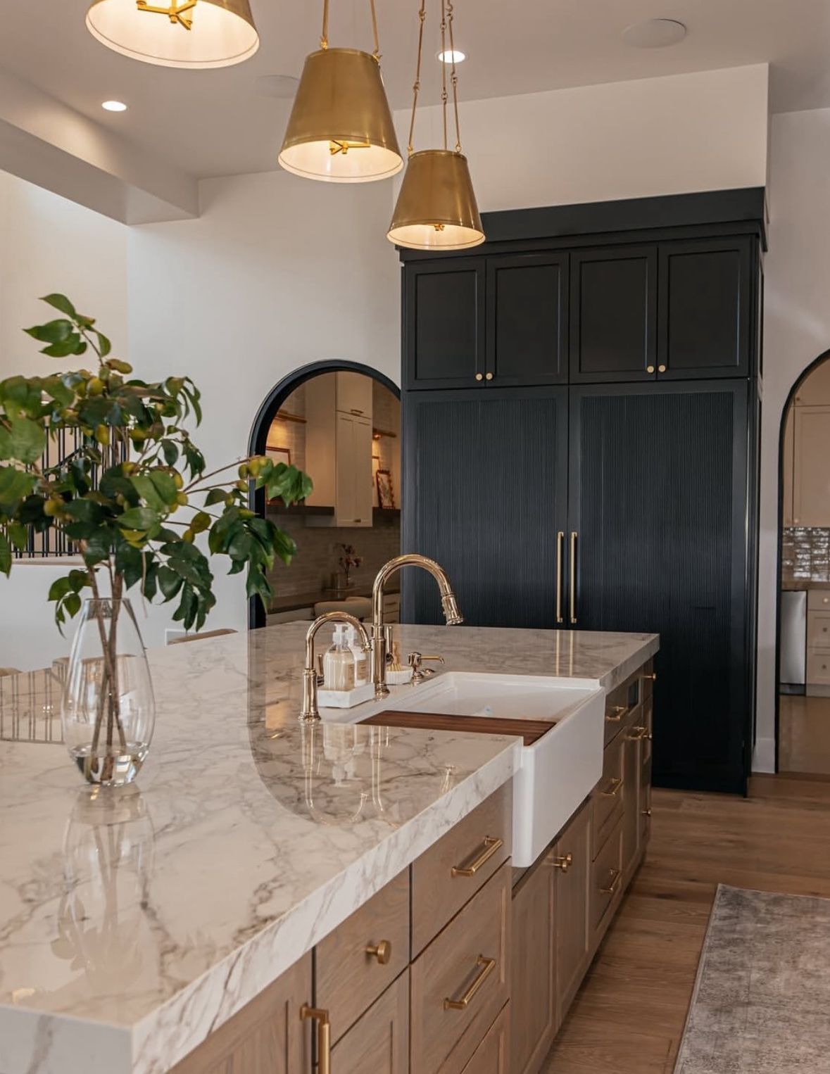 Living room with leather furniture, fireplace, and open doorway to dining area.