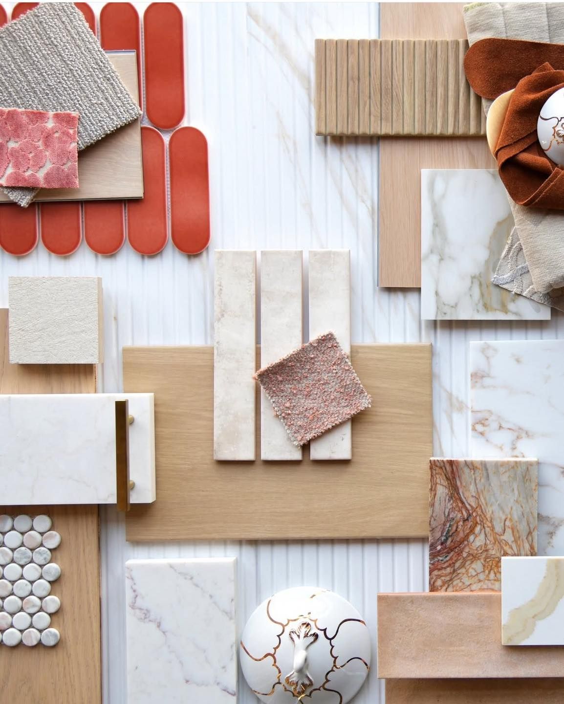Mood board with various textures and colors including wood, tile, fabric, and marble in neutral and reddish tones.