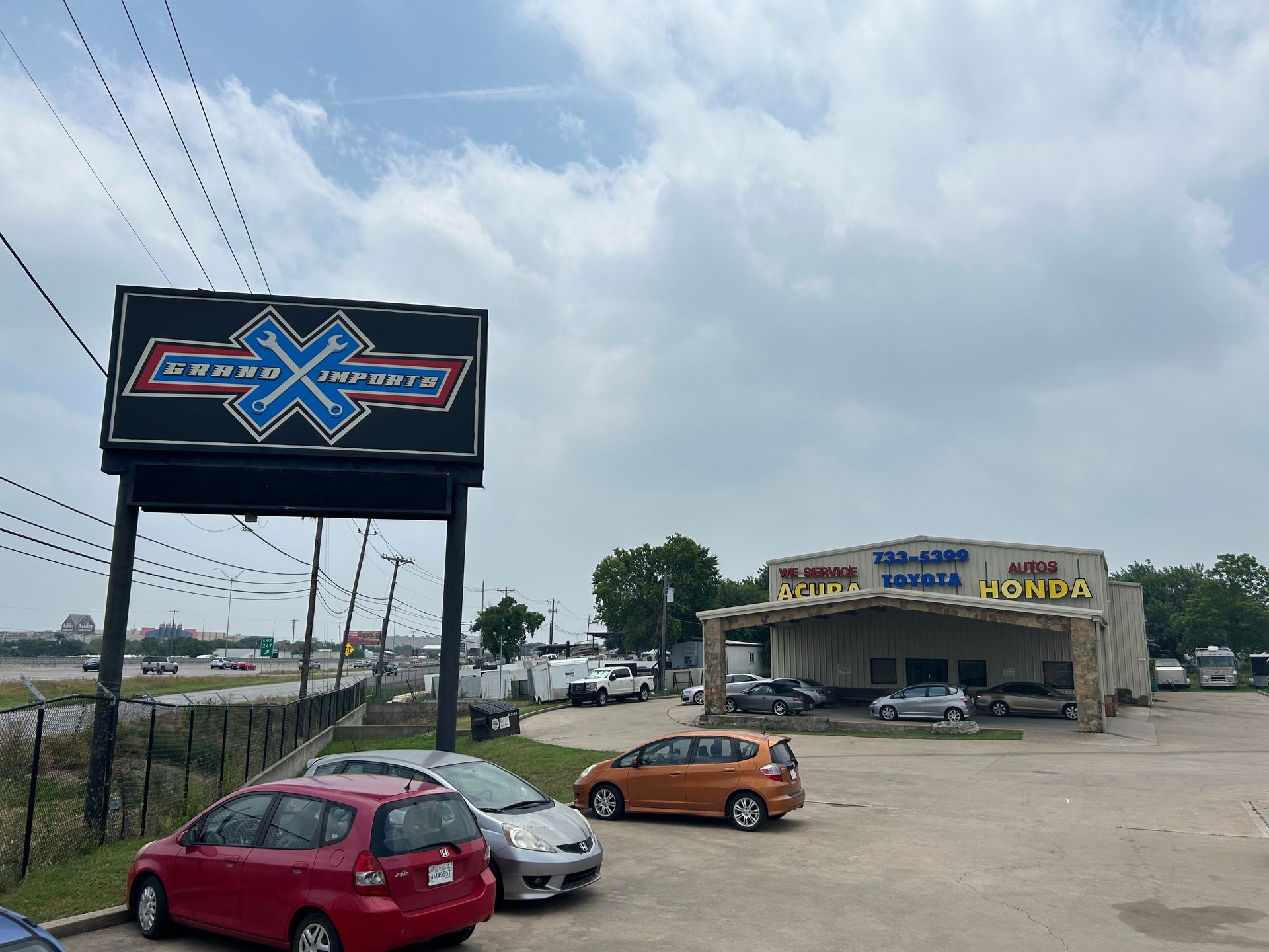 Car dealership with a sign that reads 