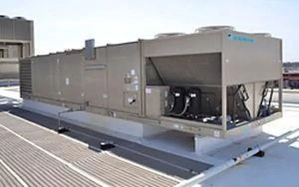 Large industrial HVAC unit on a rooftop, light grey metal, with various vents and components.