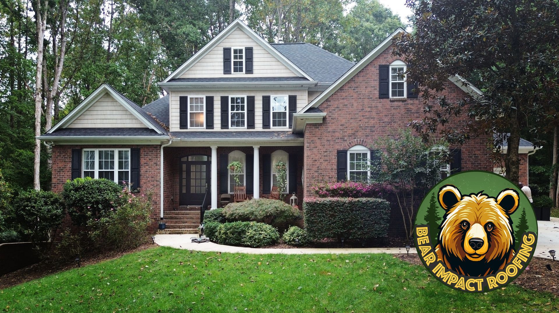 Brown brick house with black shutters, green lawn, trees, and a 