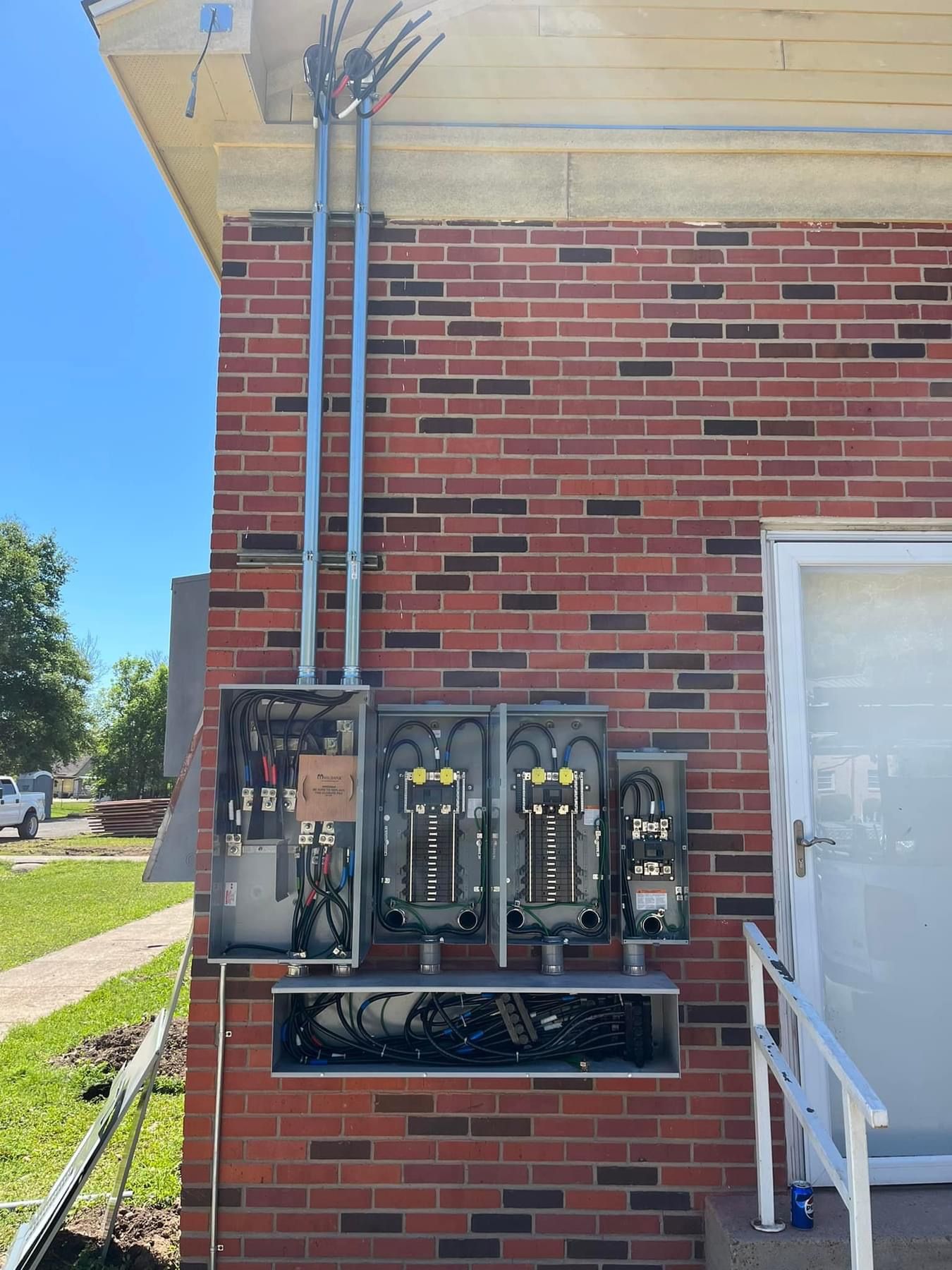 A brick building with a bunch of electrical boxes on it