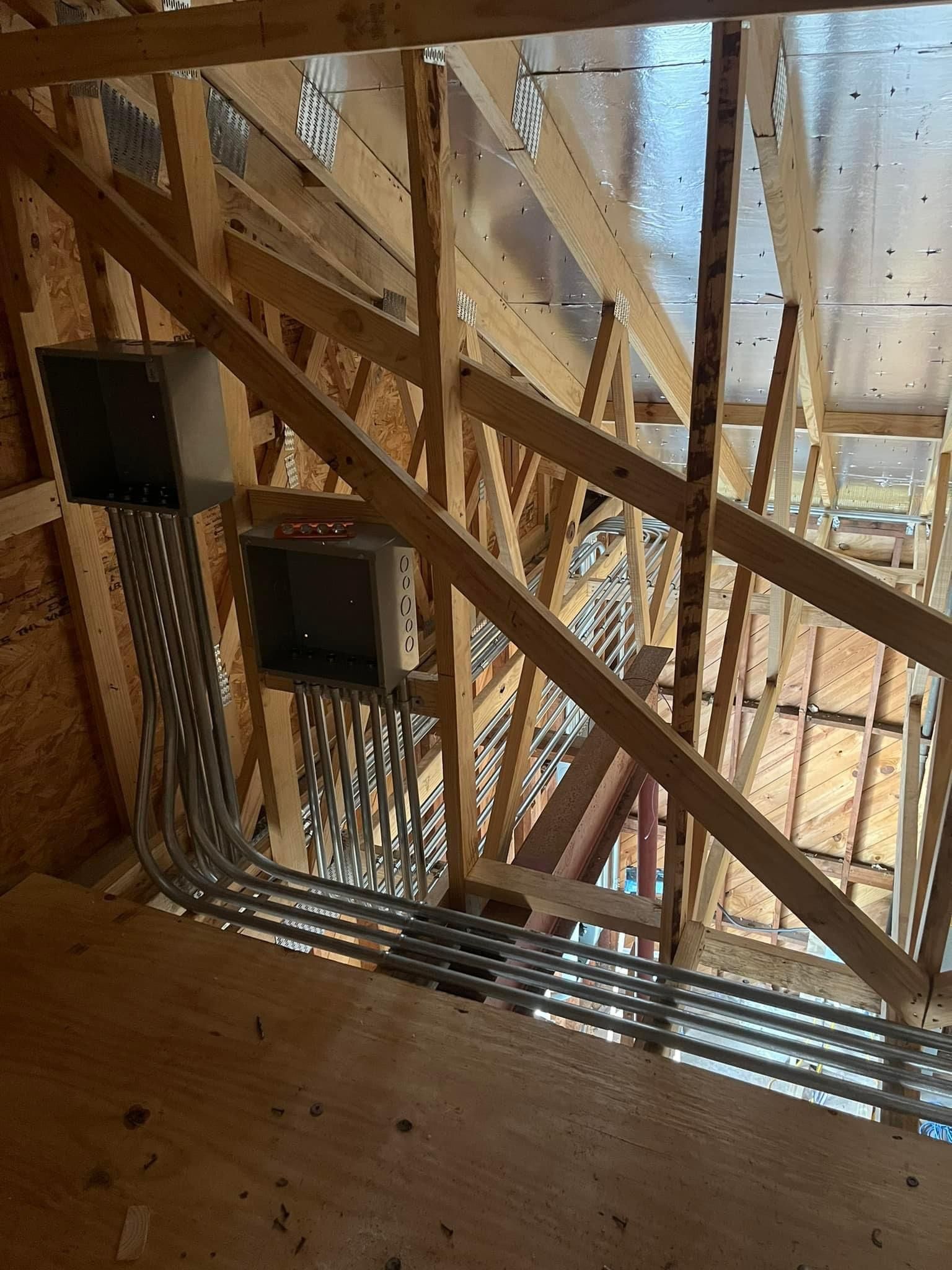A building under construction with a lot of wires coming out of the ceiling.