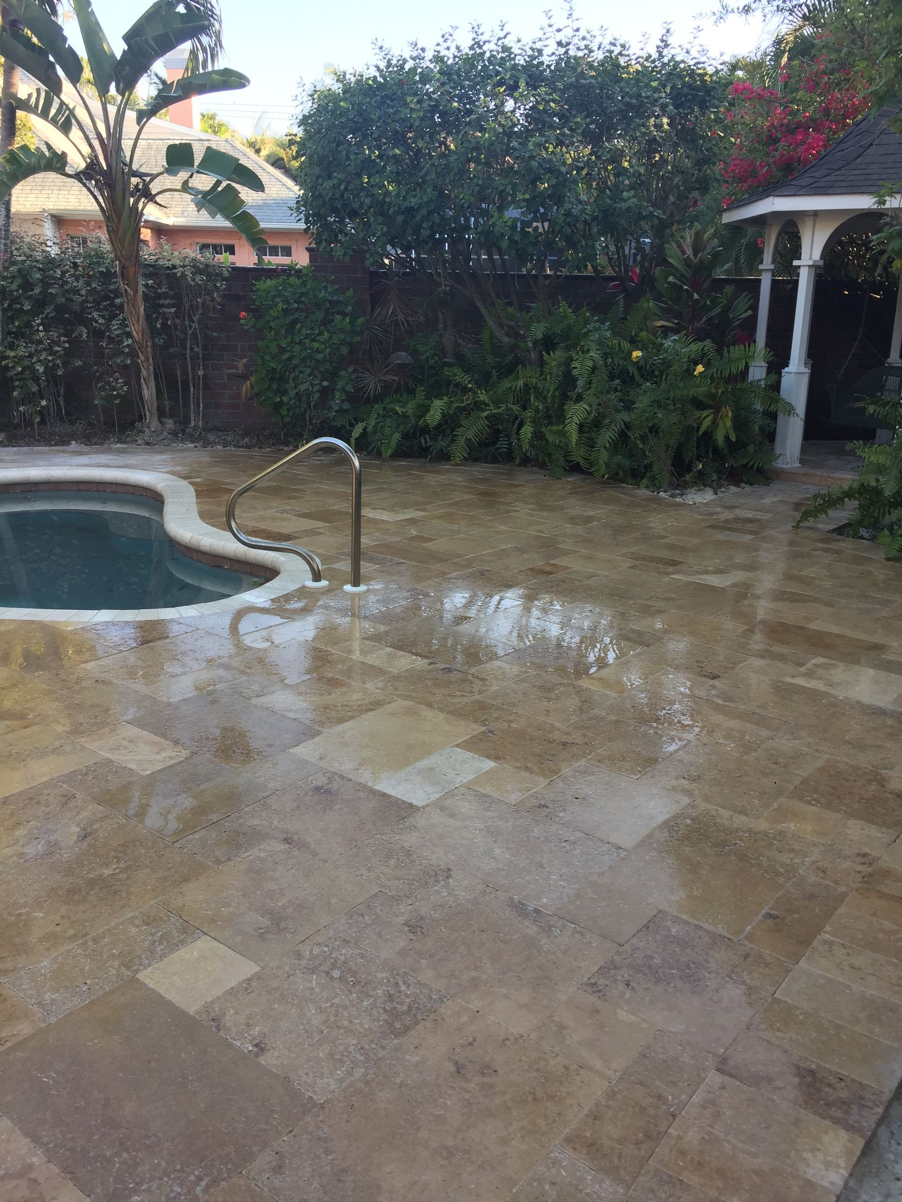 a swimming pool with a hot tub next to it