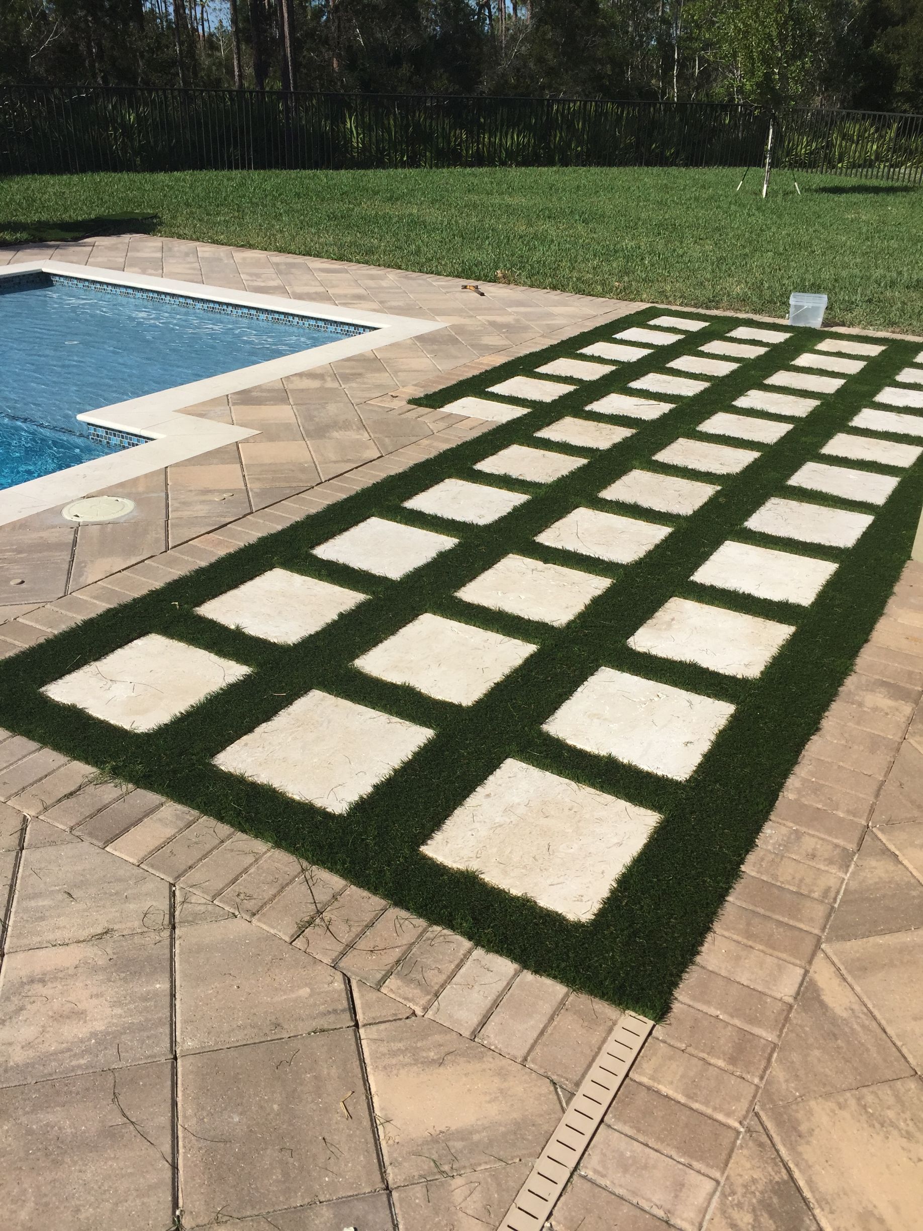 a circular brick walkway is being built in a yard 