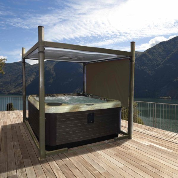 A hot tub on a deck with mountains in the background