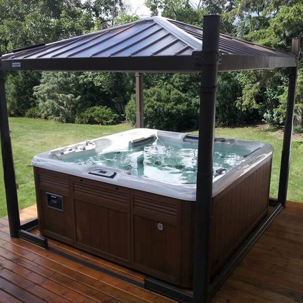 A hot tub under a canopy on a wooden deck