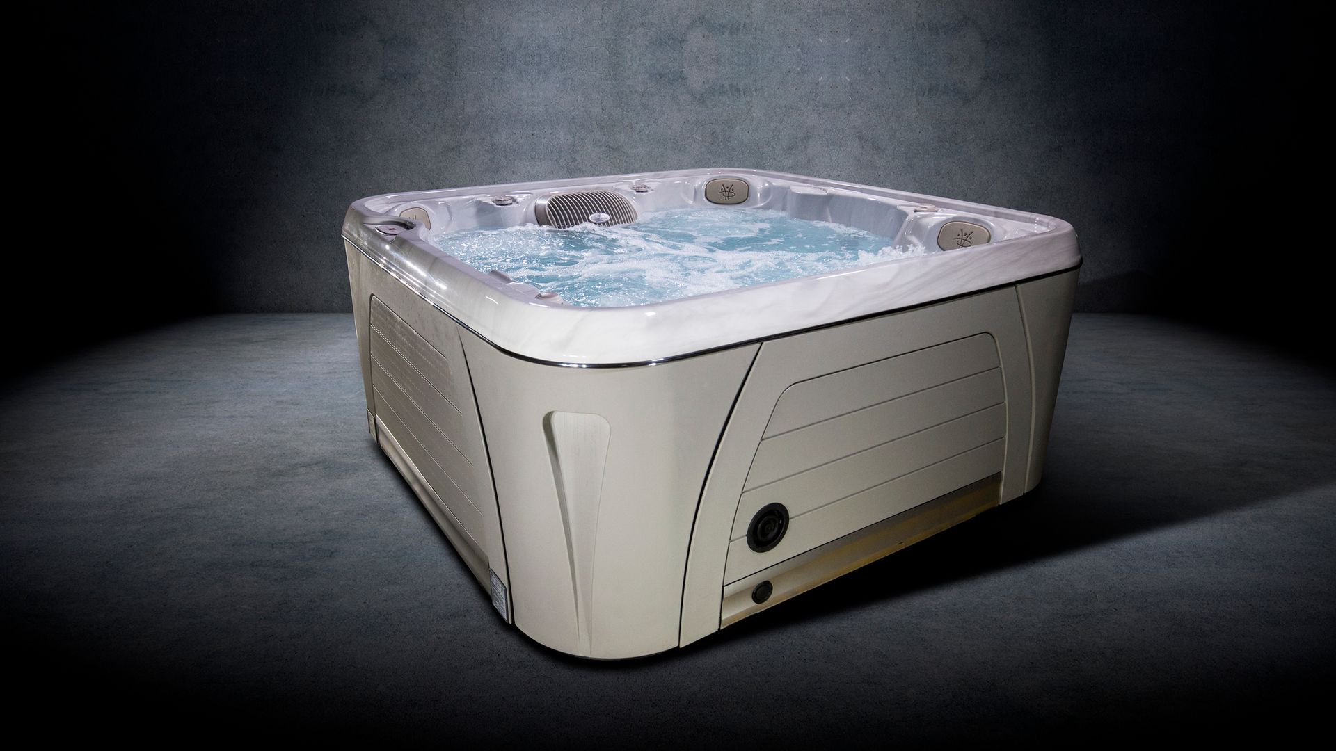 A white hot tub is sitting in a dark room