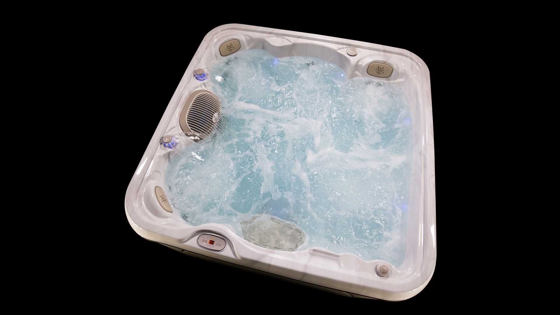 A white hot tub is filled with blue water on a black background.