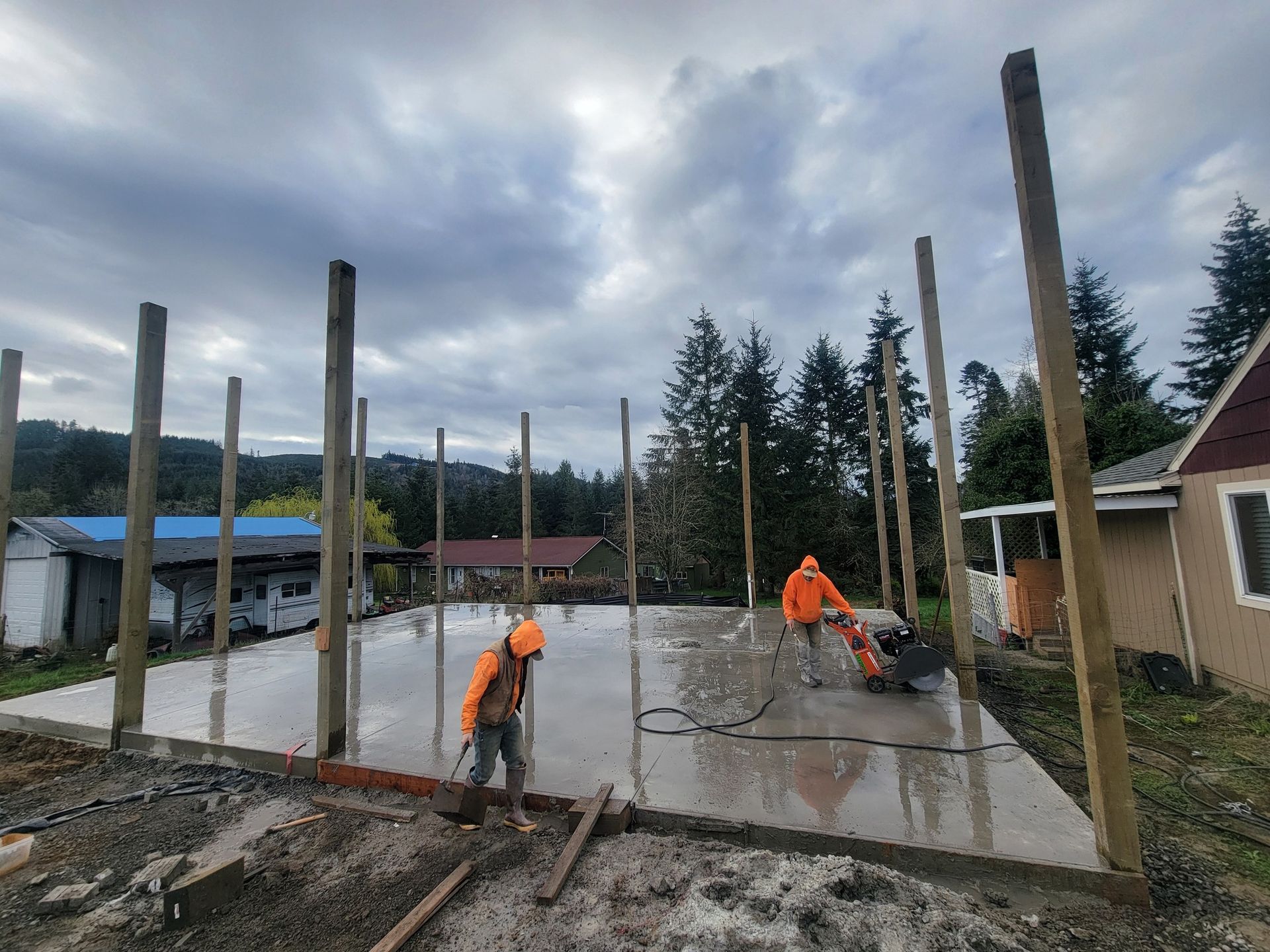 A group of construction workers are working on a concrete floor.