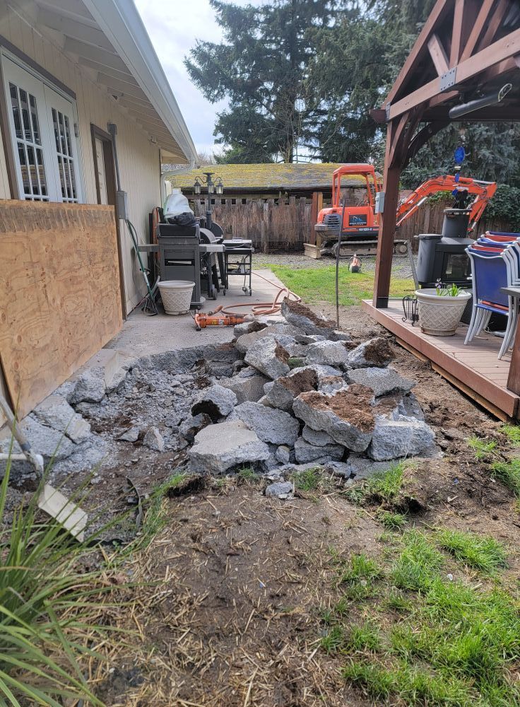 A pile of rocks is sitting in front of a house.