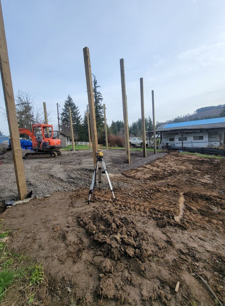 A tripod is sitting in the middle of a dirt field.