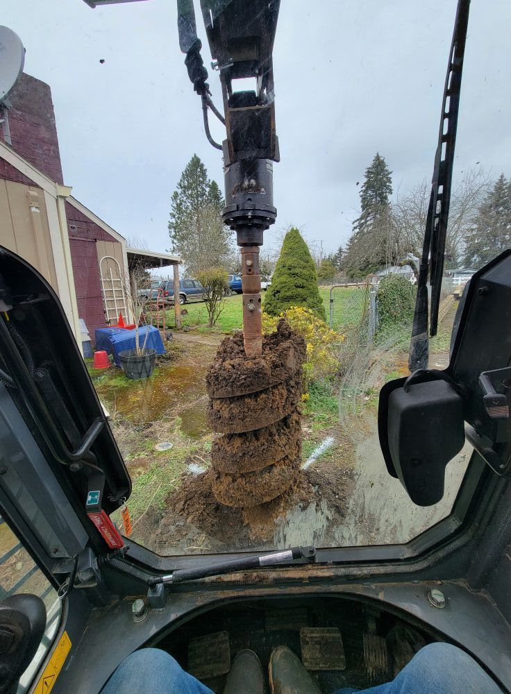 A person is sitting in the driver 's seat of a tractor.