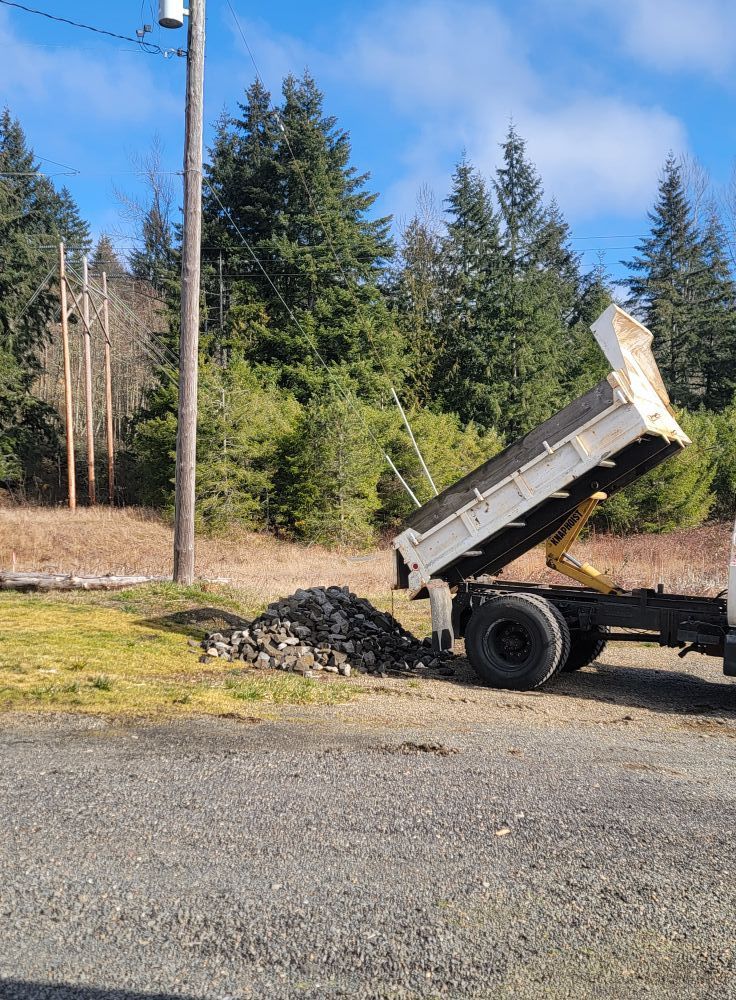 A dump truck is parked on the side of the road.
