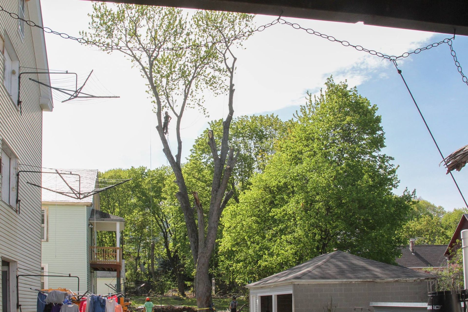 Clothes are hanging on a clothes line outside of a house