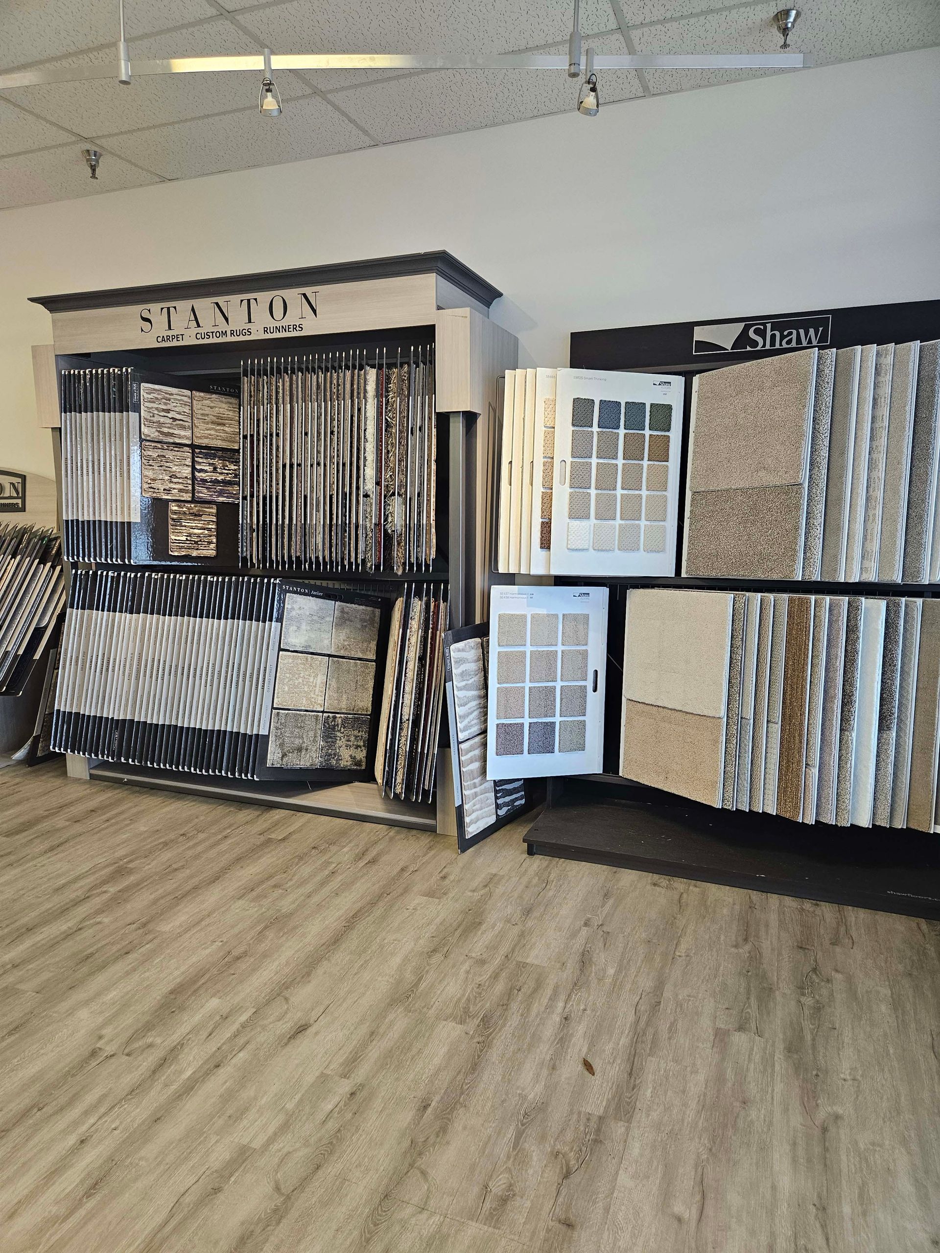 a room with a lot of carpets on display in a store .