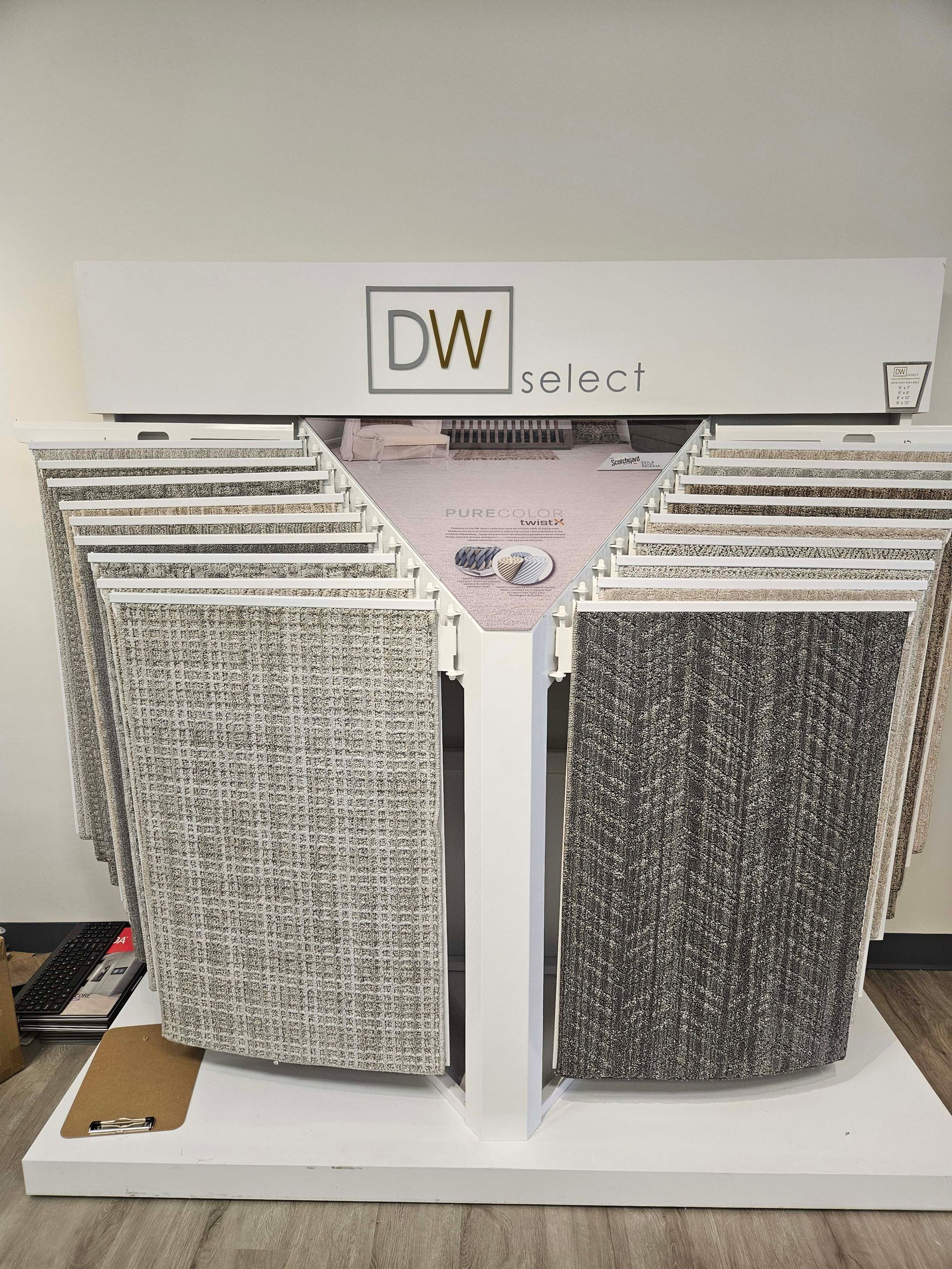 a display of carpets on a stand in a store .