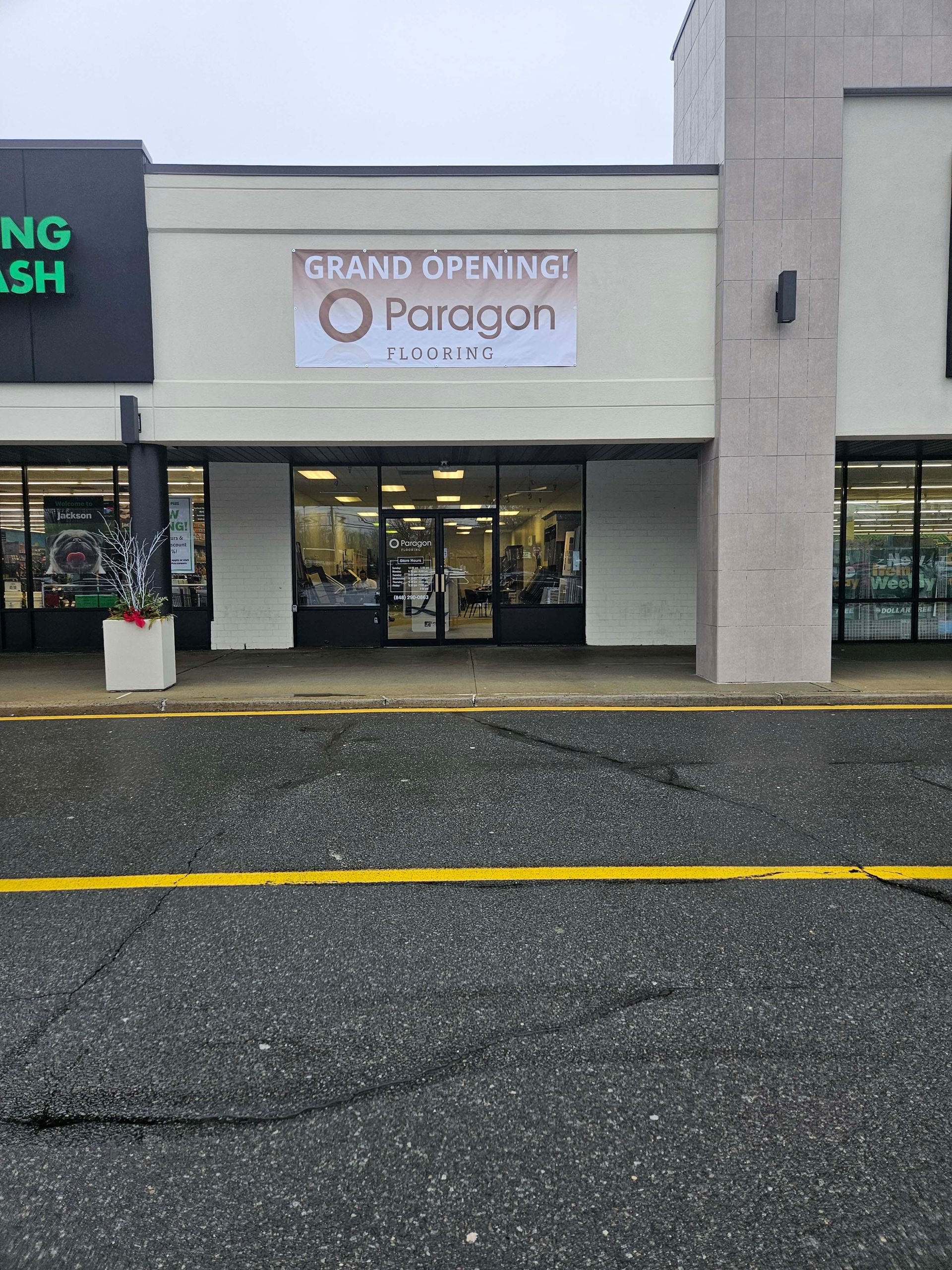 a store front with a sign that says grand opening paragon