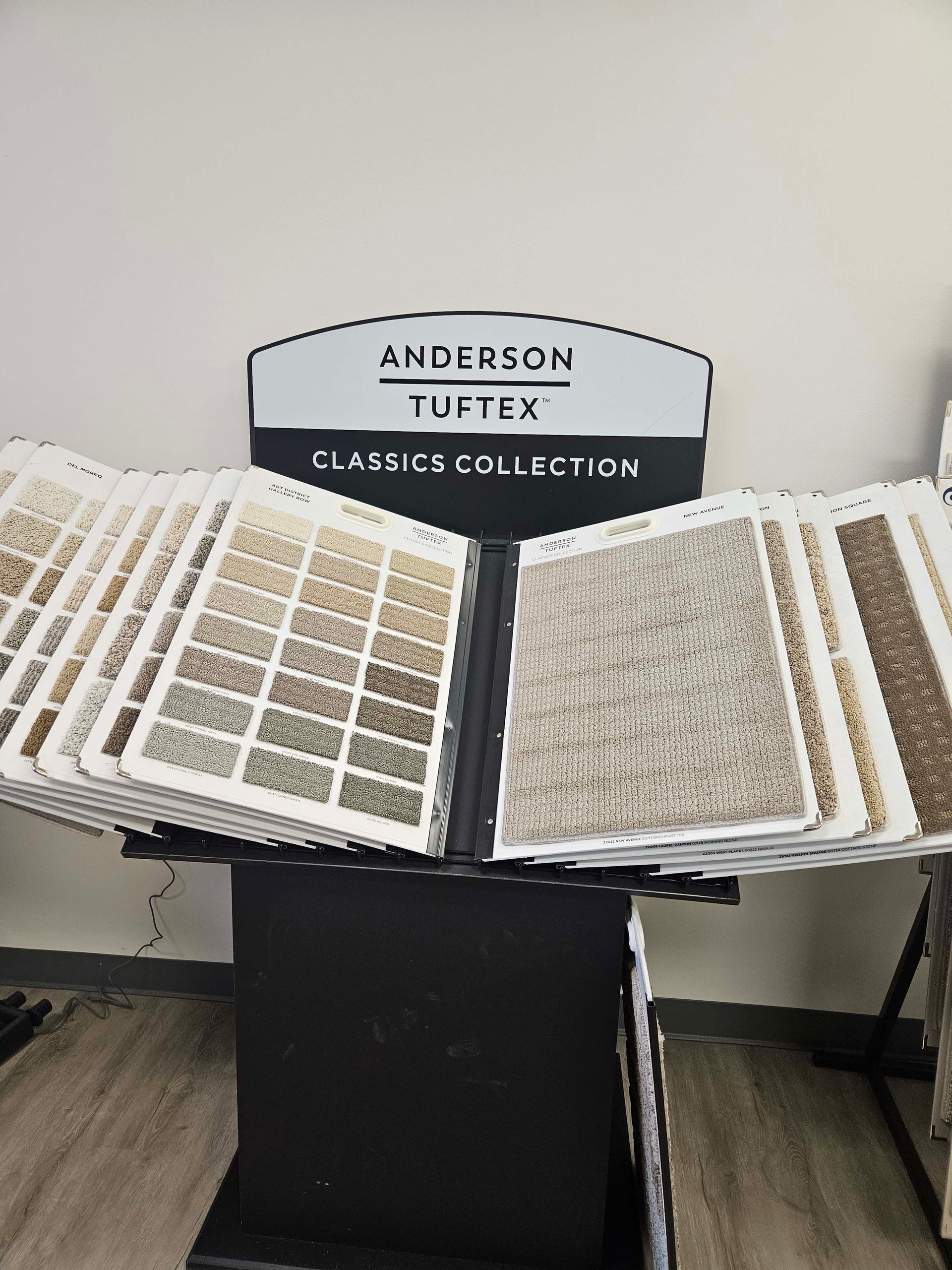 a display of carpet samples on a stand in a store .