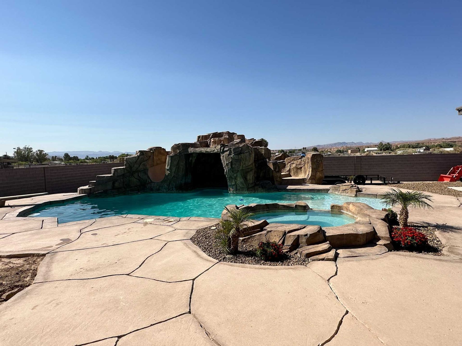 A large swimming pool with a waterfall in the background