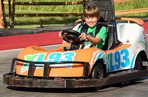 Boy driving go kart vehicle