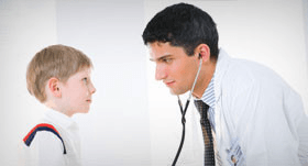 Man with stethoscope staring at a boy's eyes