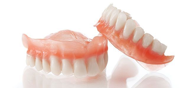 A pair of dentures on a white surface