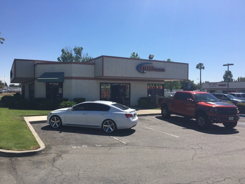 Cars parked in front of a car audio installation shop