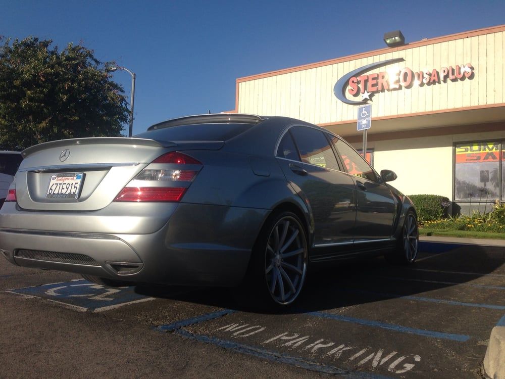 Mercedes-Benz parked in front of a car audio installation shop