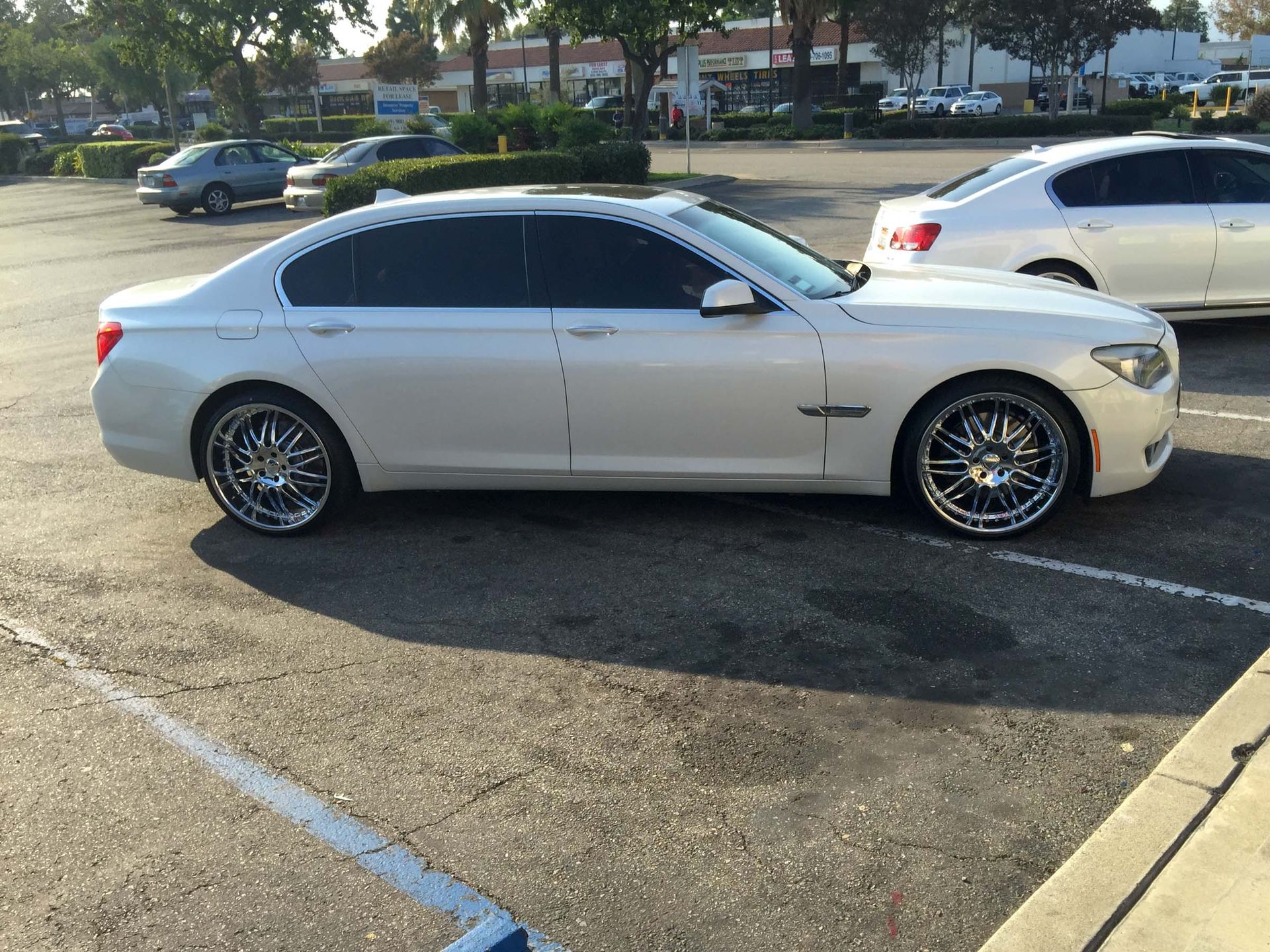 BMW parked in front of a car audio installation shop