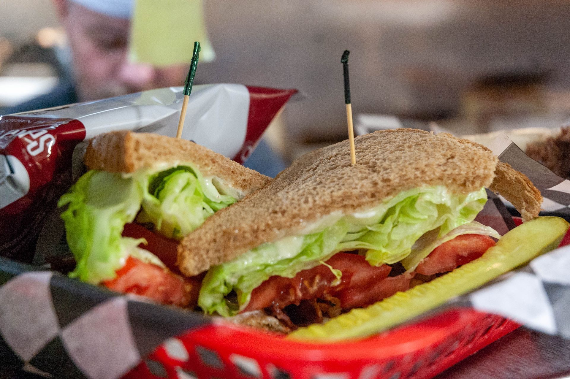 A close up of a sandwich in a basket on a table.