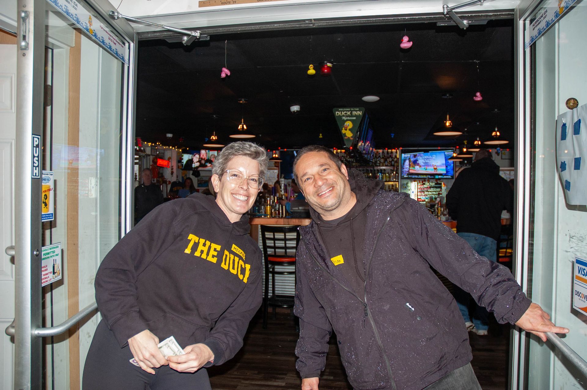 A man and a woman are standing next to each other in a doorway.