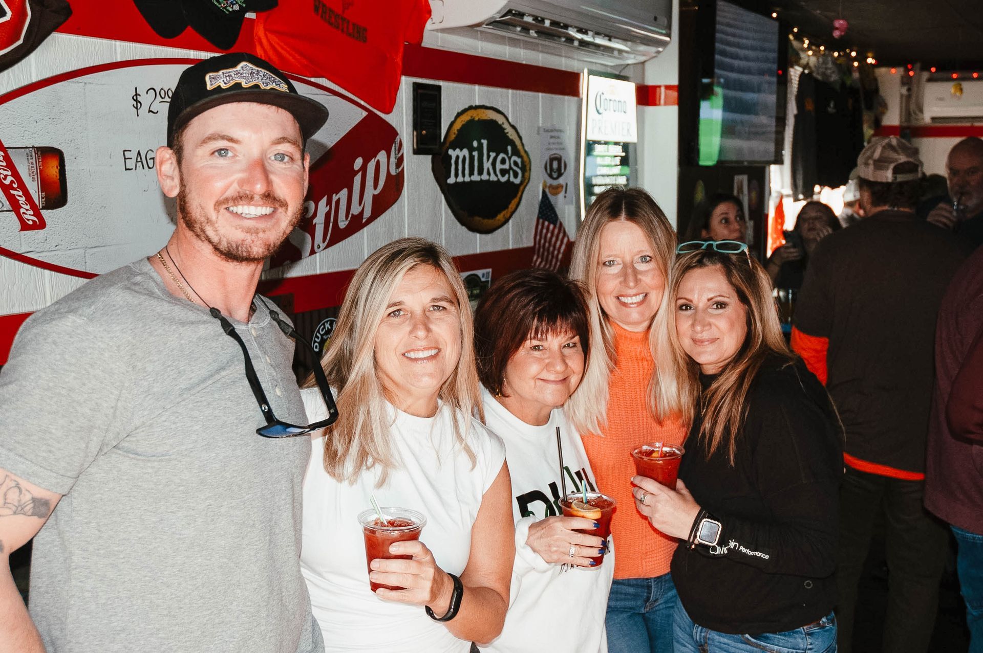 A group of people are posing for a picture in front of a mikes truck.