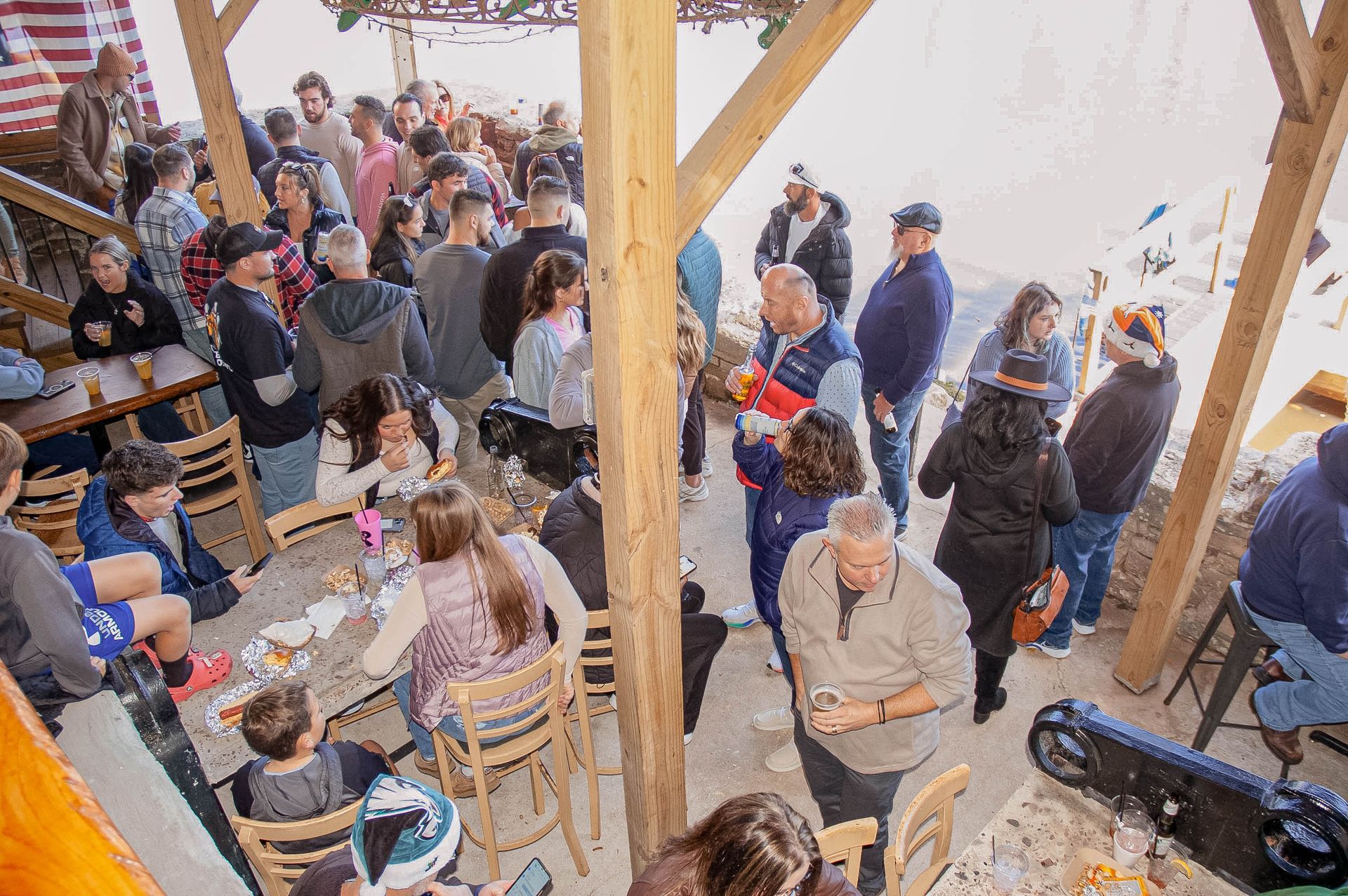 A large group of people are sitting at tables in a restaurant.