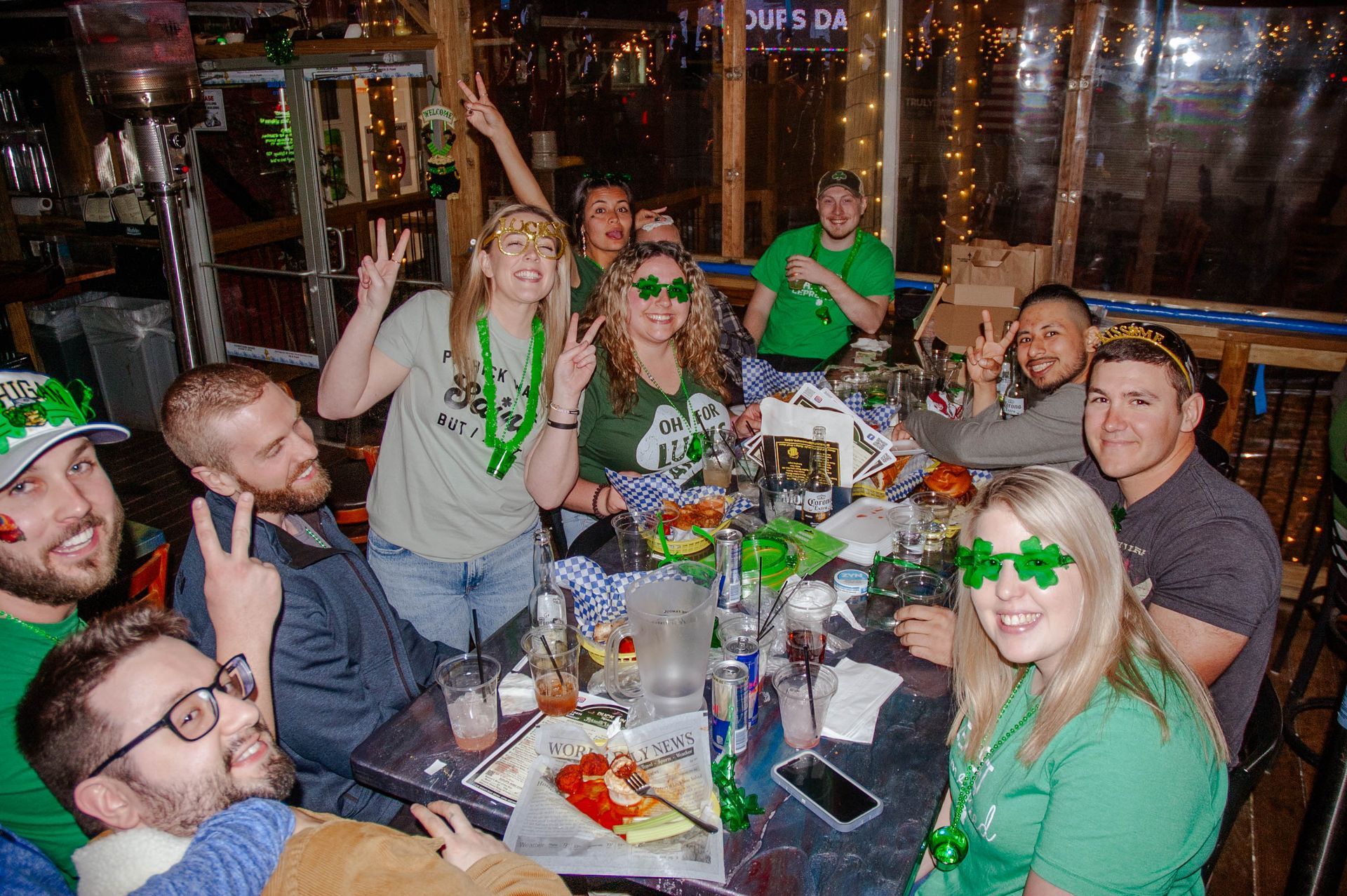 A group of people are sitting around a table in a restaurant.