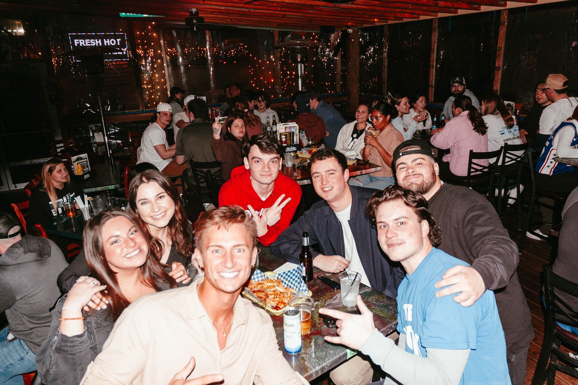 A group of people are sitting at tables in a restaurant.