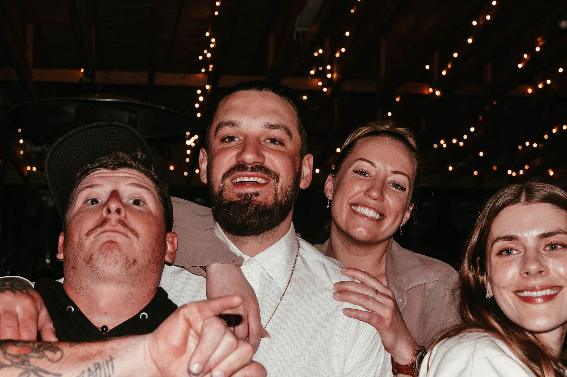 A group of people are posing for a picture together at a party.