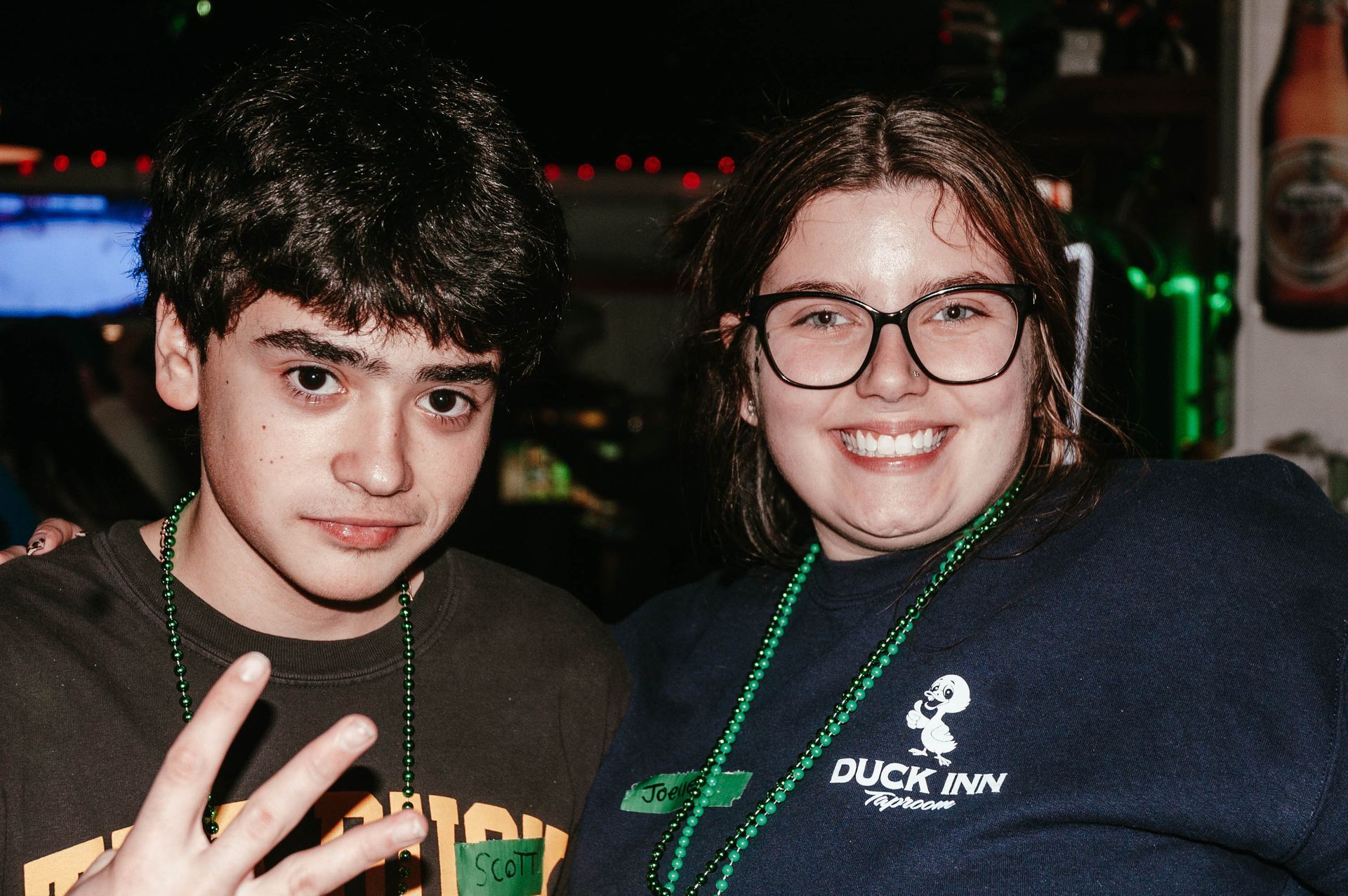 A boy and a girl are posing for a picture together.