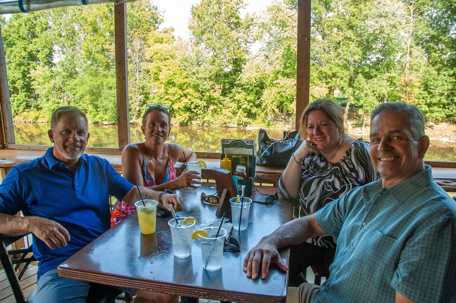 A group of people are sitting at a table with drinks.