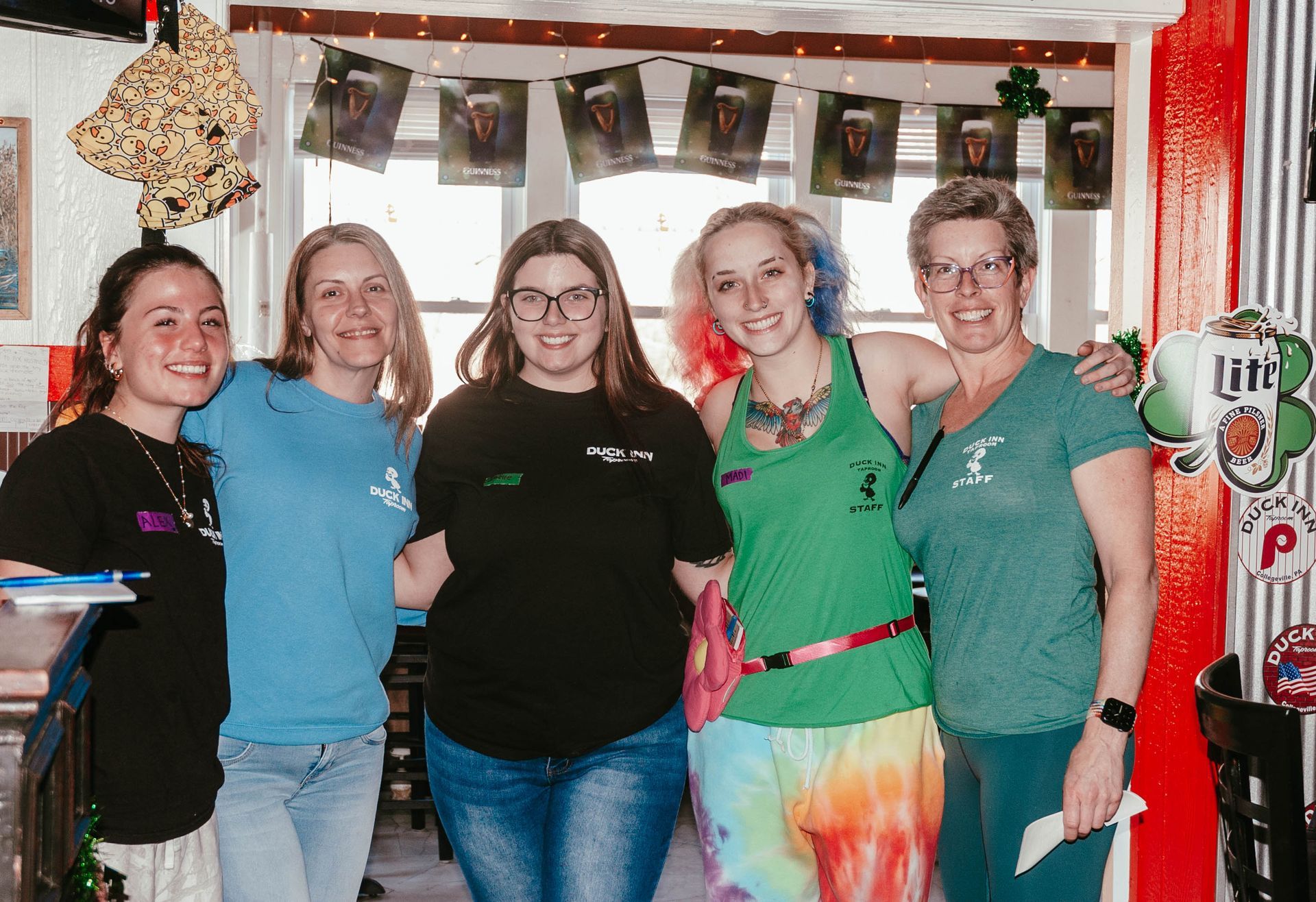 A group of women are posing for a picture together in a room.