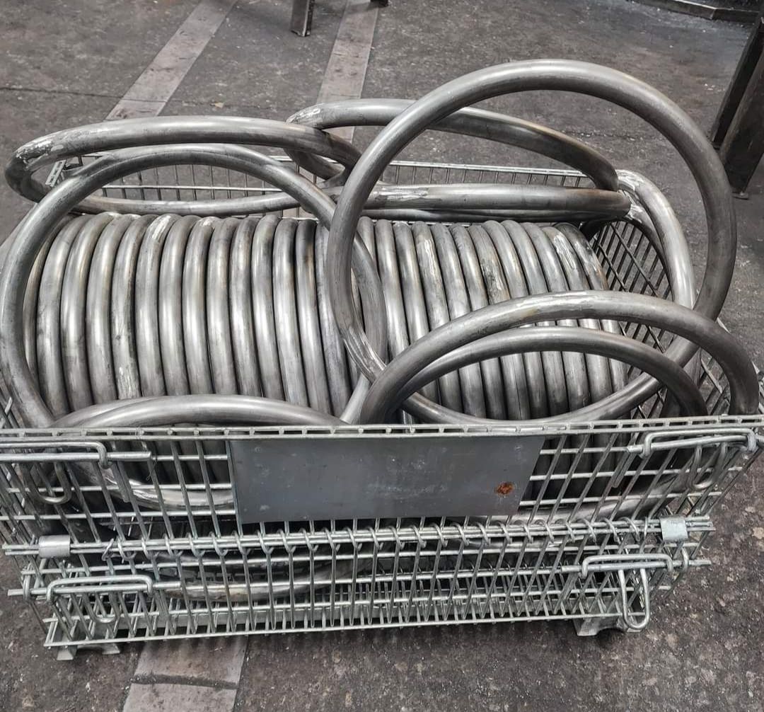 A bunch of metal pipes in a wire basket