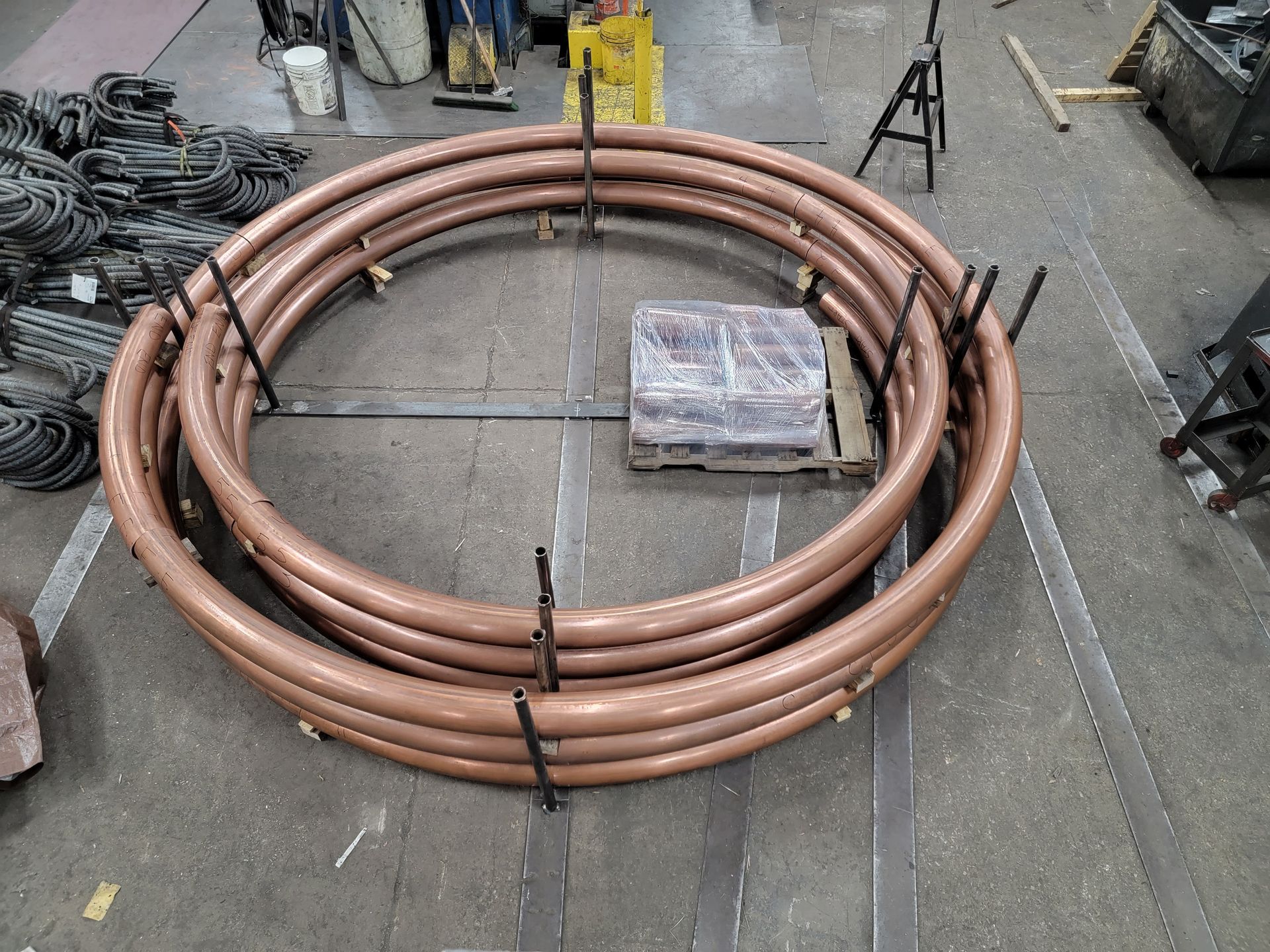 A bunch of copper pipes are stacked on top of each other