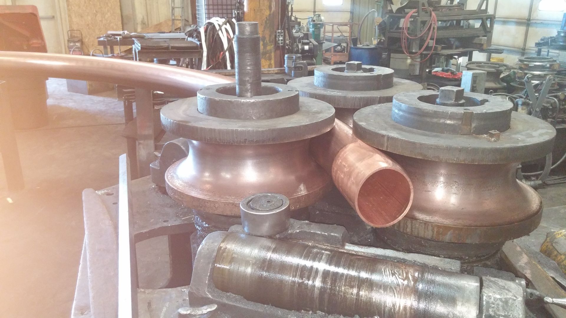 A machine is making copper pipes in a factory.