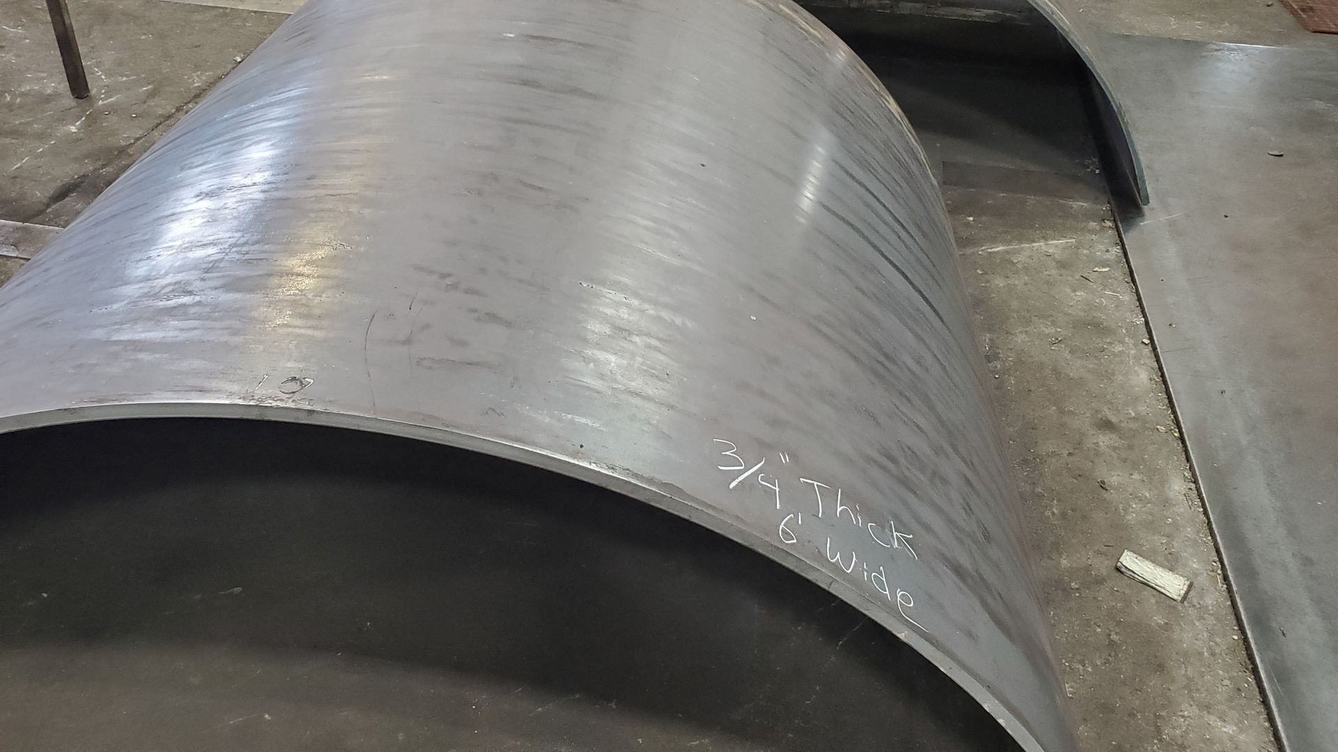 A close up of a metal pipe sitting on top of a table.
