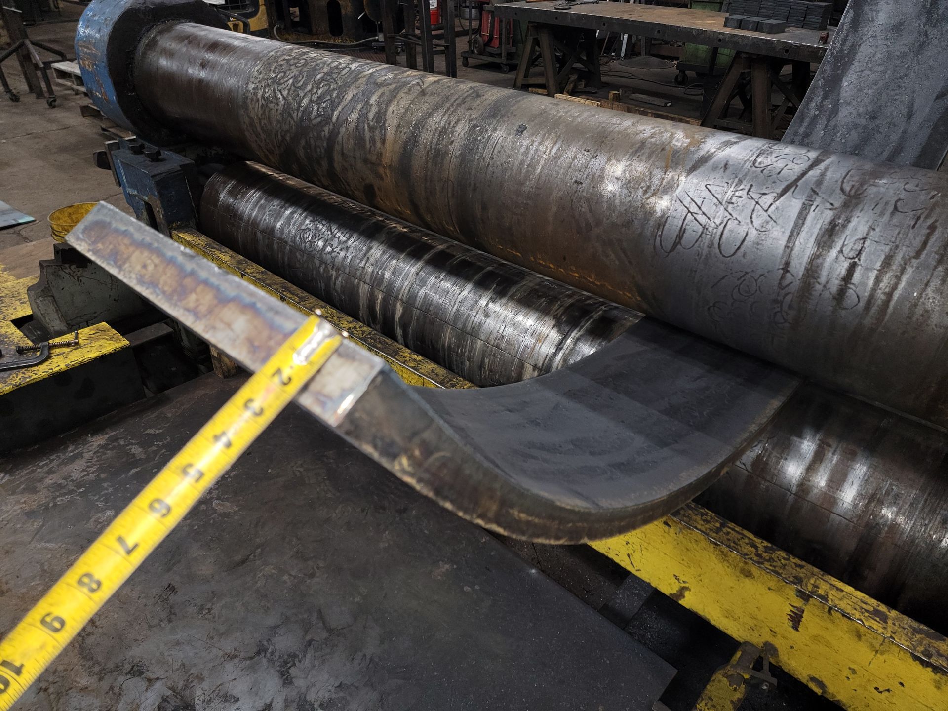 A metal rolling machine is being used to roll a piece of metal.