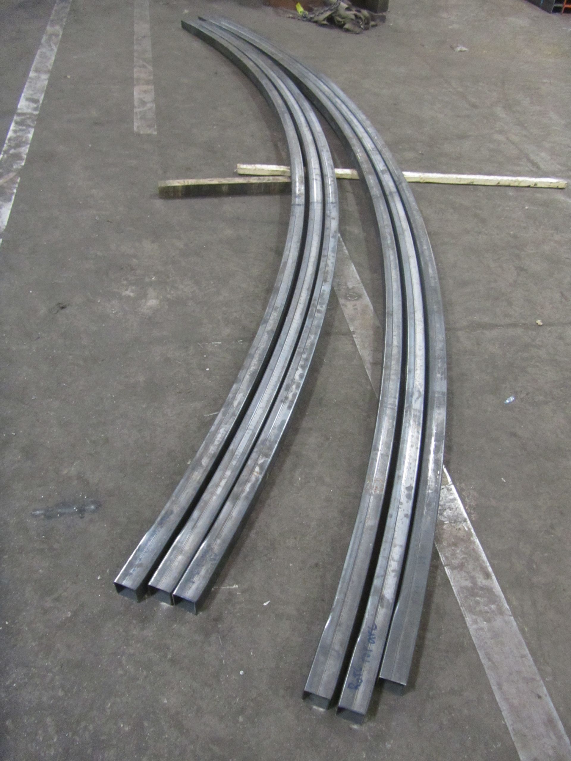 A bunch of metal pipes are laying on the ground