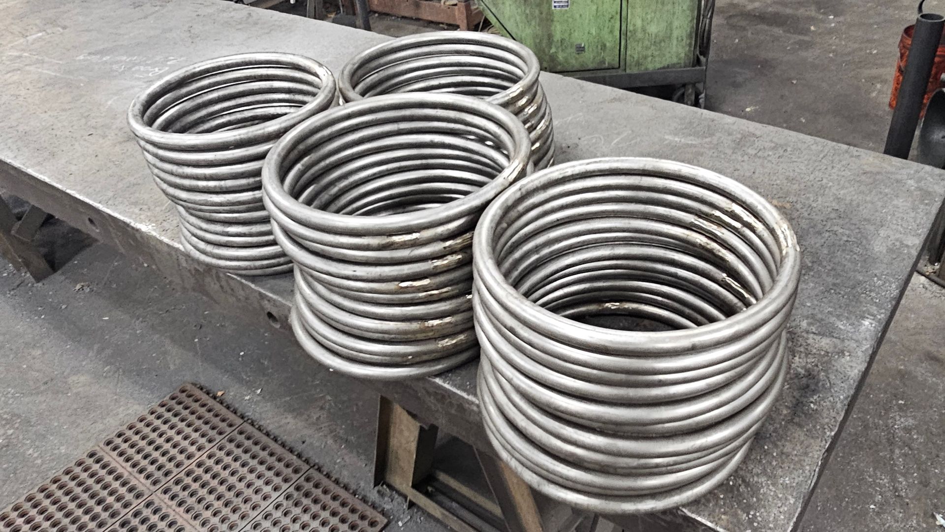 A bunch of metal rings are stacked on top of each other on a table.