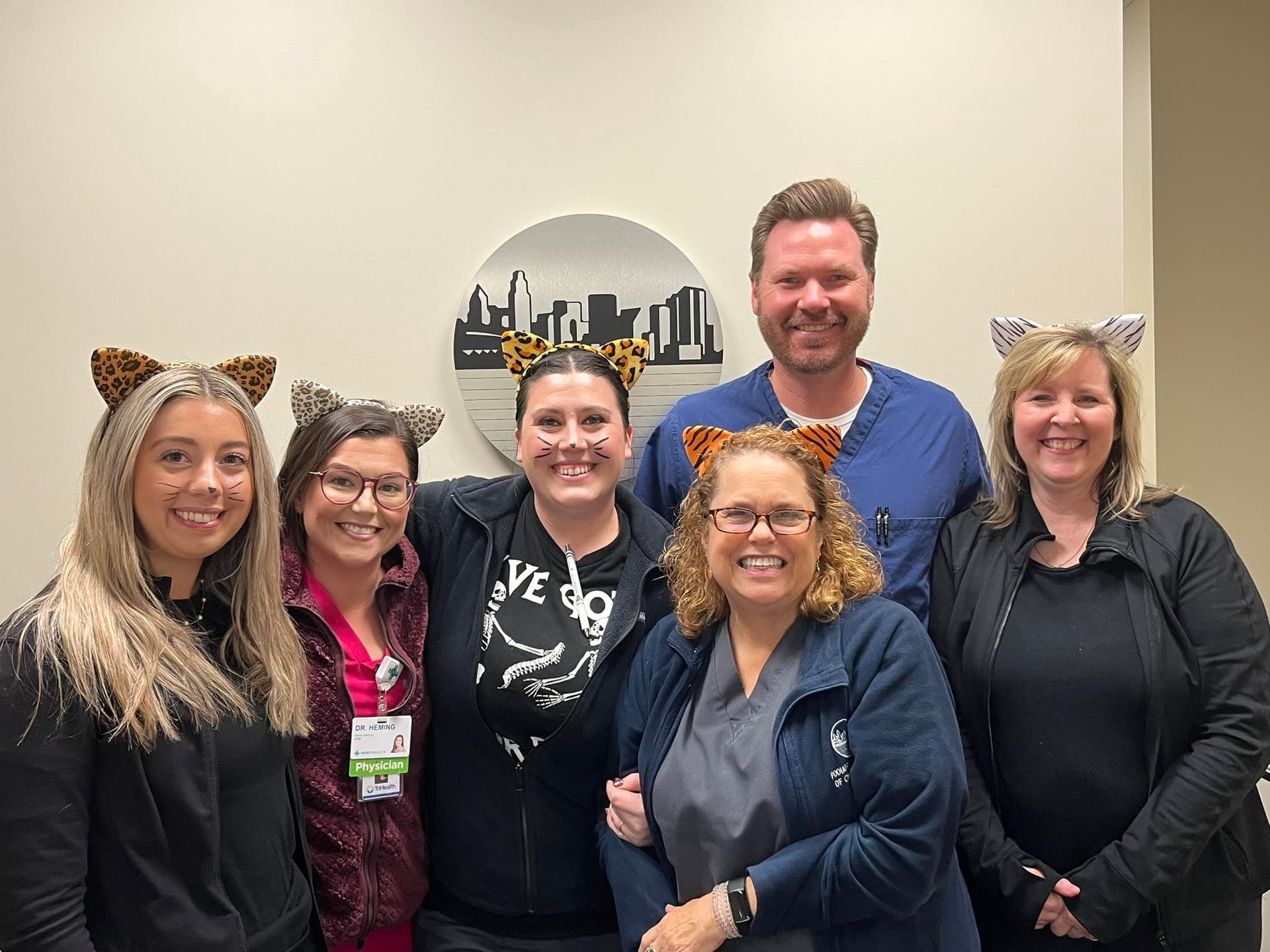 A group of people wearing cat ears are posing for a picture.